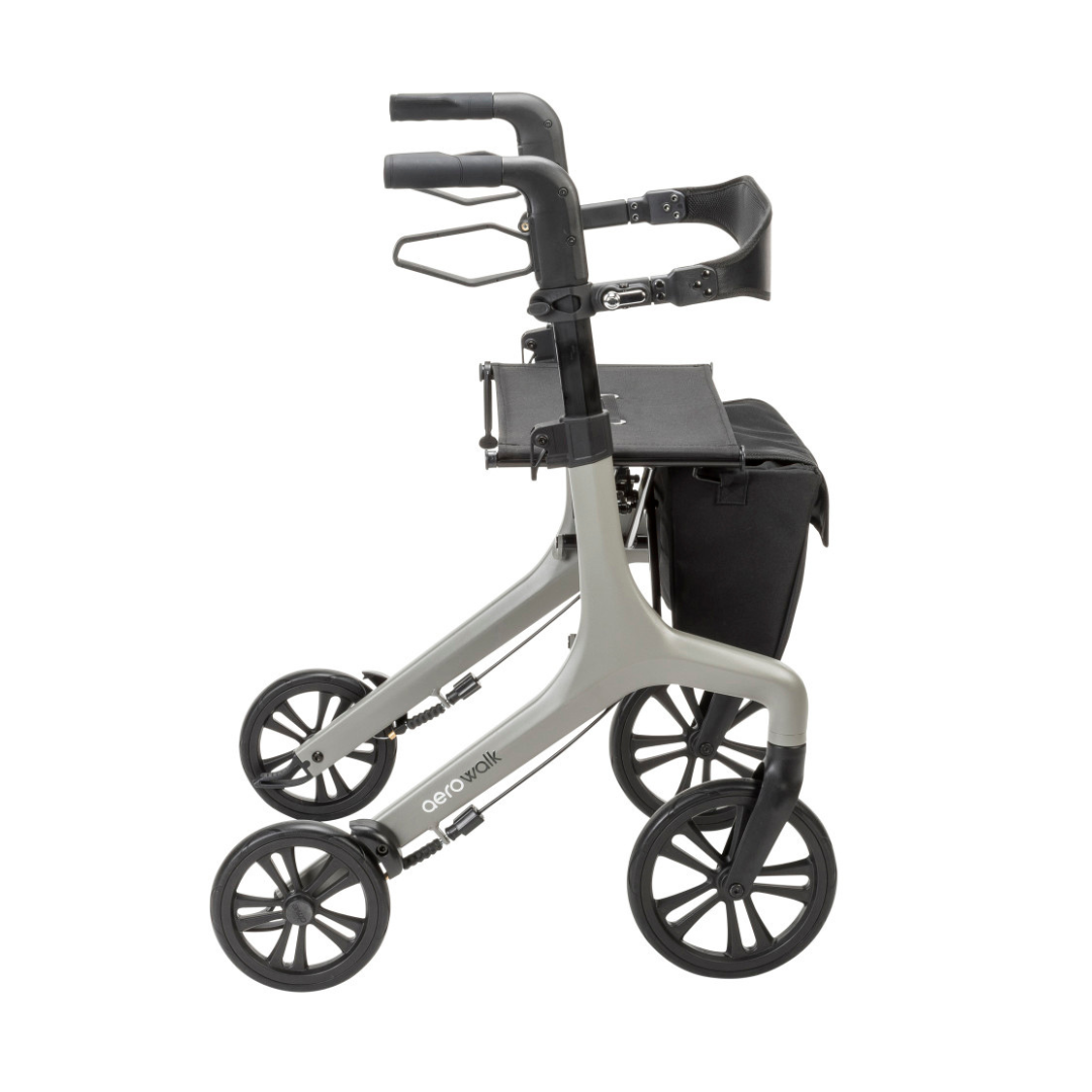 The Drive AeroWalk Ultra-Lite Rollator is shown in a side profile view, featuring four large black wheels, ergonomic handles, a black seat, and an attached storage bag.