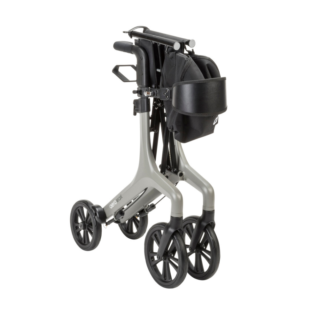 The Drive AeroWalk Ultra-Lite Rollator is a foldable, ultra-light rollator with four wheels, a black seat, storage pouch, and gray frame, shown compactly folded for easy mobility support, transport, or storage.