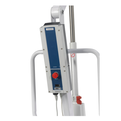 Close-up of a medical device control panel with a blue and white LINAK box, red emergency stop button, and battery indicator, mounted on the white metal frame of a Drive Bariatric Battery-Powered Patient Lift.