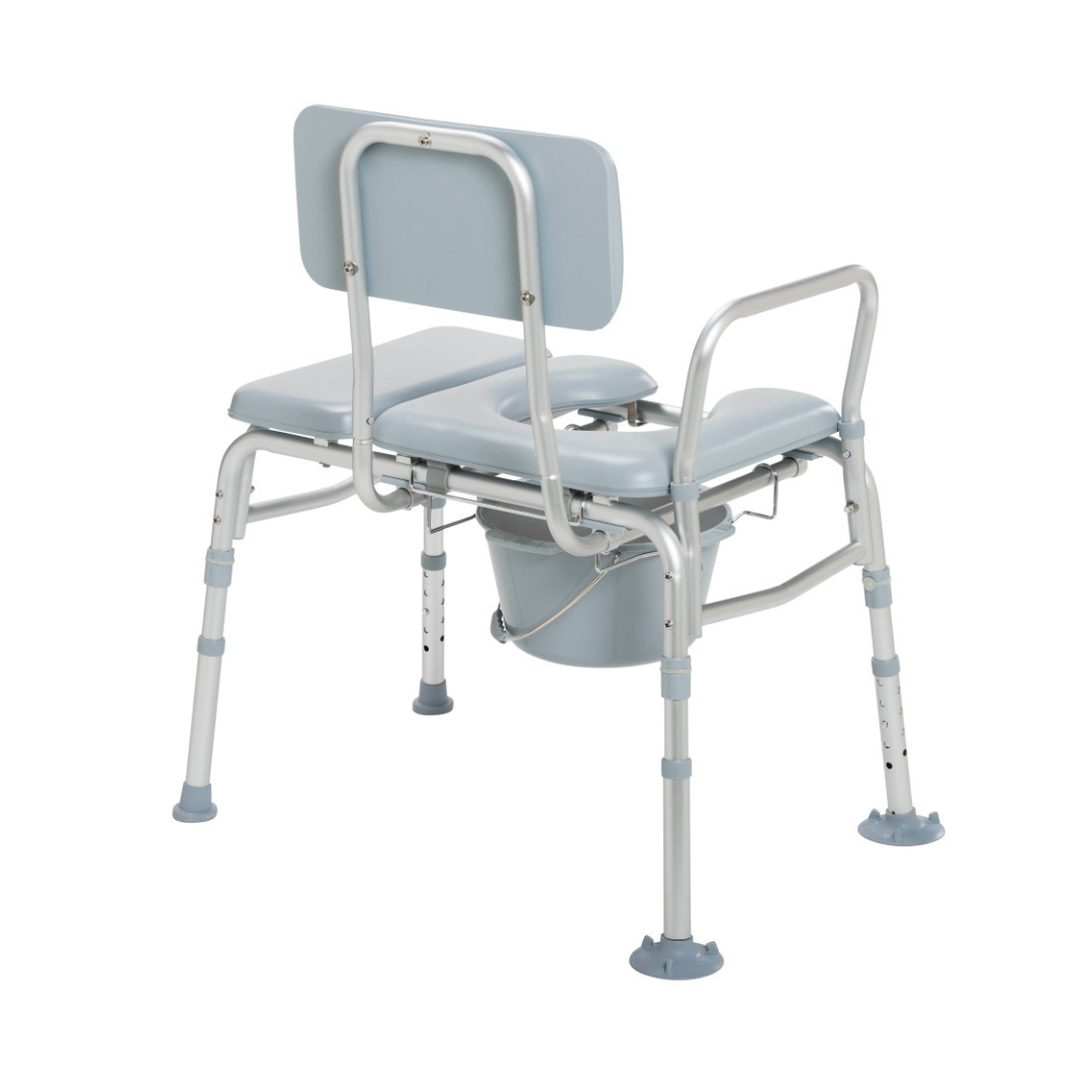 The Drive Combination Padded Transfer Bench/Commode in light blue and silver features an adjustable padded seat, armrests, backrest, and a removable bucket—offering comfort and convenience for bathing or toileting needs.