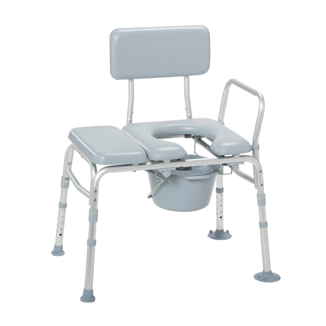 The Drive Combination Padded Transfer Bench/Commode is a light blue and silver adjustable chair with armrests, a backrest, padded open seat, and a removable bucket, offering versatile support for individuals with mobility challenges.