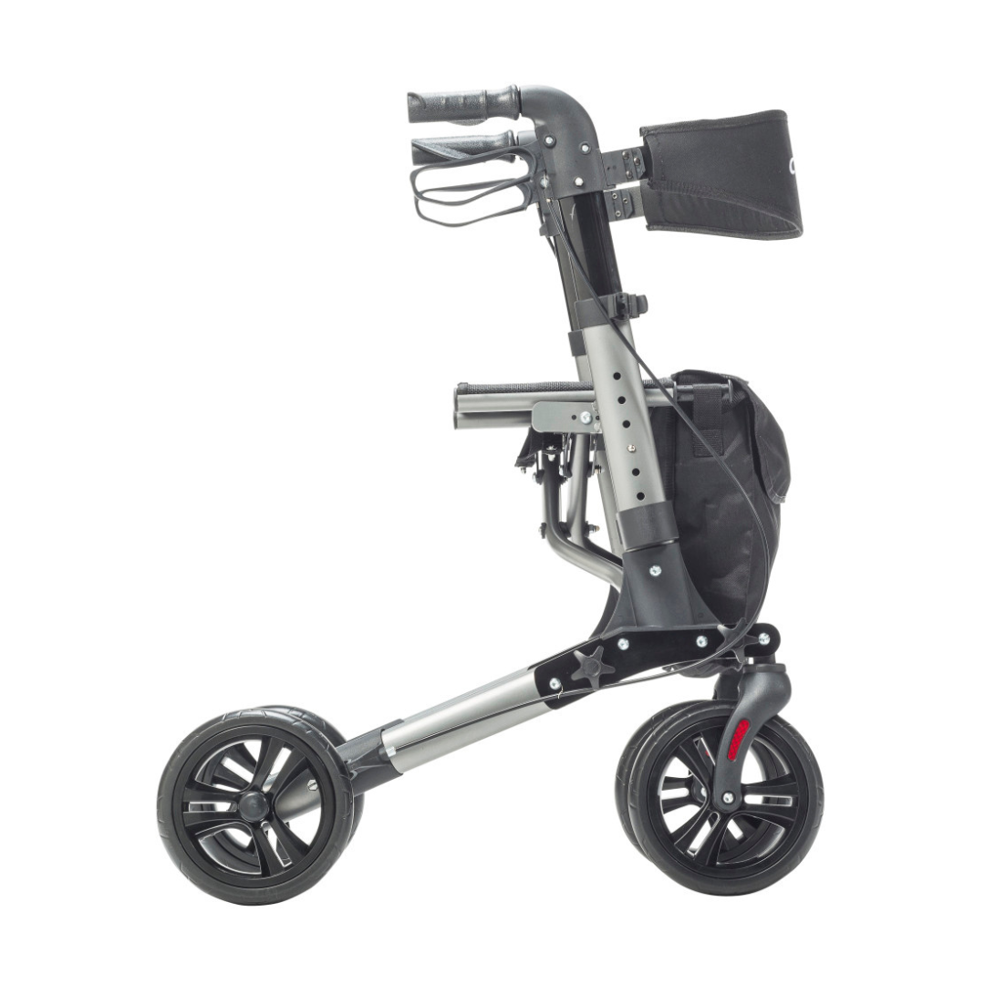 The Drive Lightweight Portable Rollator - Ultra Compact Fold features a black frame, large wheels, hand brakes, and a small front storage bag. Shown from the side on a white background.