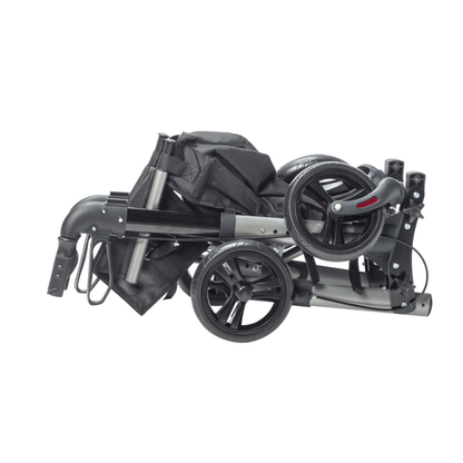 A Drive Lightweight Portable Rollator - Ultra Compact Fold in black and gray is shown folded, with its handles, frame, and fabric parts neatly collapsed together for portability.