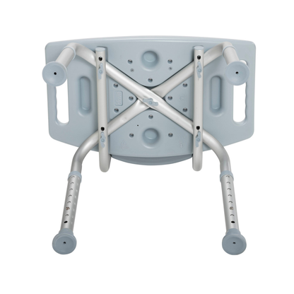 The Drive Deluxe Aluminum Bath Chair is shown upside down, featuring a light grey plastic seat with side handles, drainage holes, and four height-adjustable aluminum legs with rubber tips.
