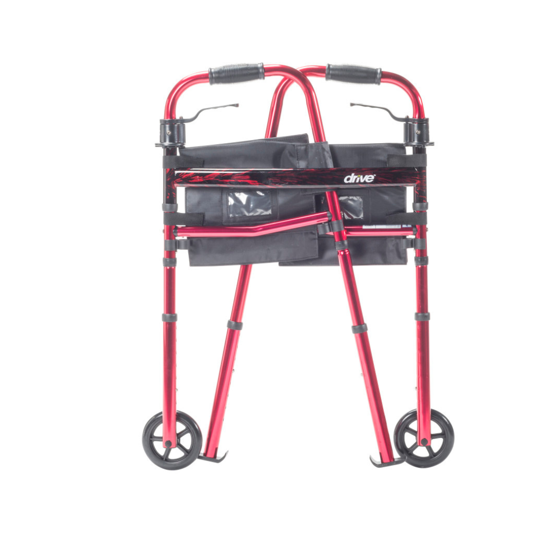 The Drive Deluxe Folding Travel Walker with 5" Wheels, shown in red with black handles, a front storage pouch, and two front wheels against a white background—an ideal compact mobility aid for daily use.