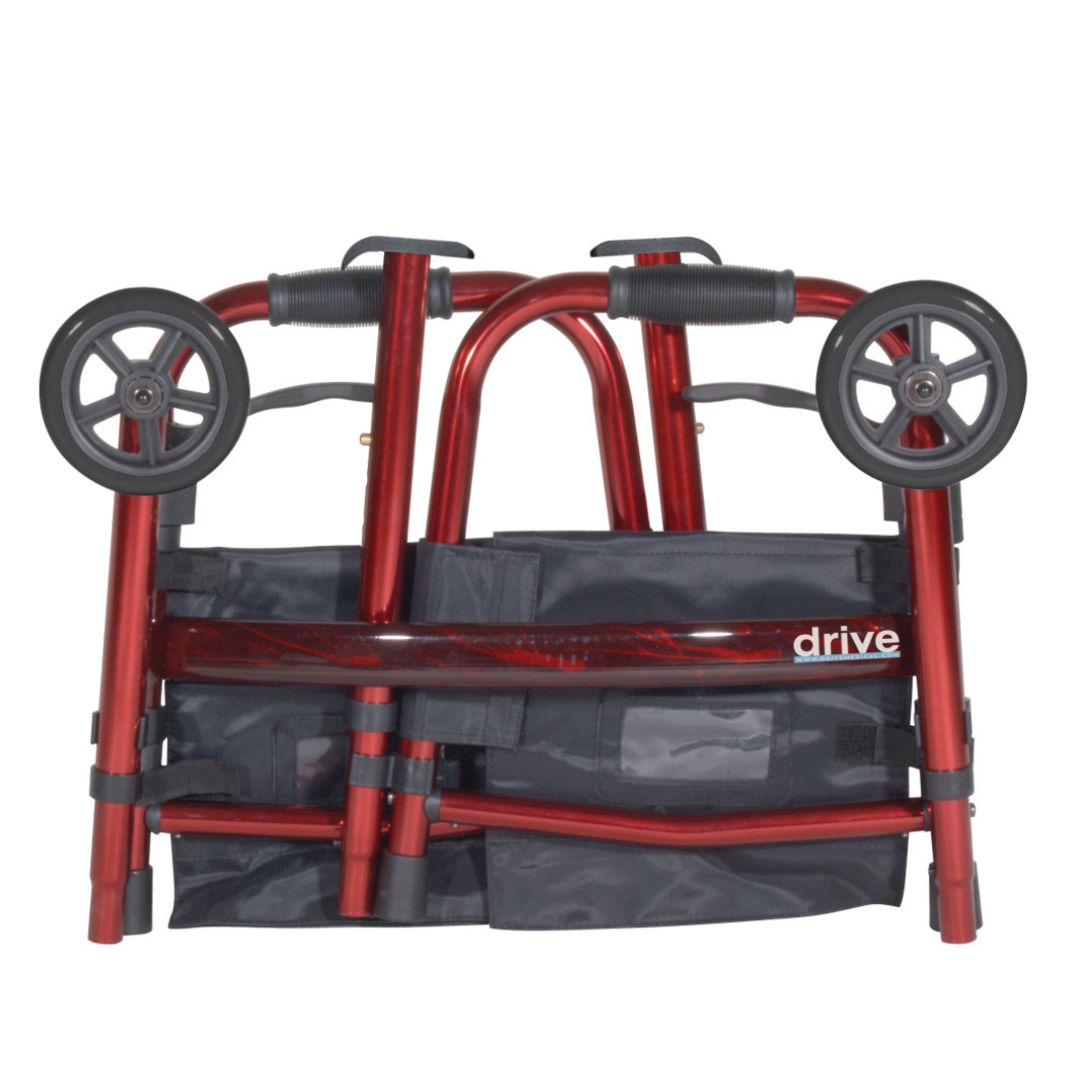 The Drive Deluxe Folding Travel Walker with 5" Wheels, shown folded in red with black grips and a visible black pouch, is a compact mobility aid designed for easy transport and convenient storage.