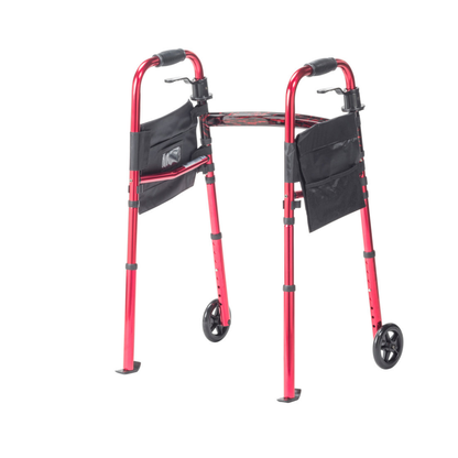The Drive Deluxe Folding Travel Walker with 5" Wheels is a red compact mobility aid featuring two front black wheels, rear rubber tips, and black side pouches, displayed against a white background.