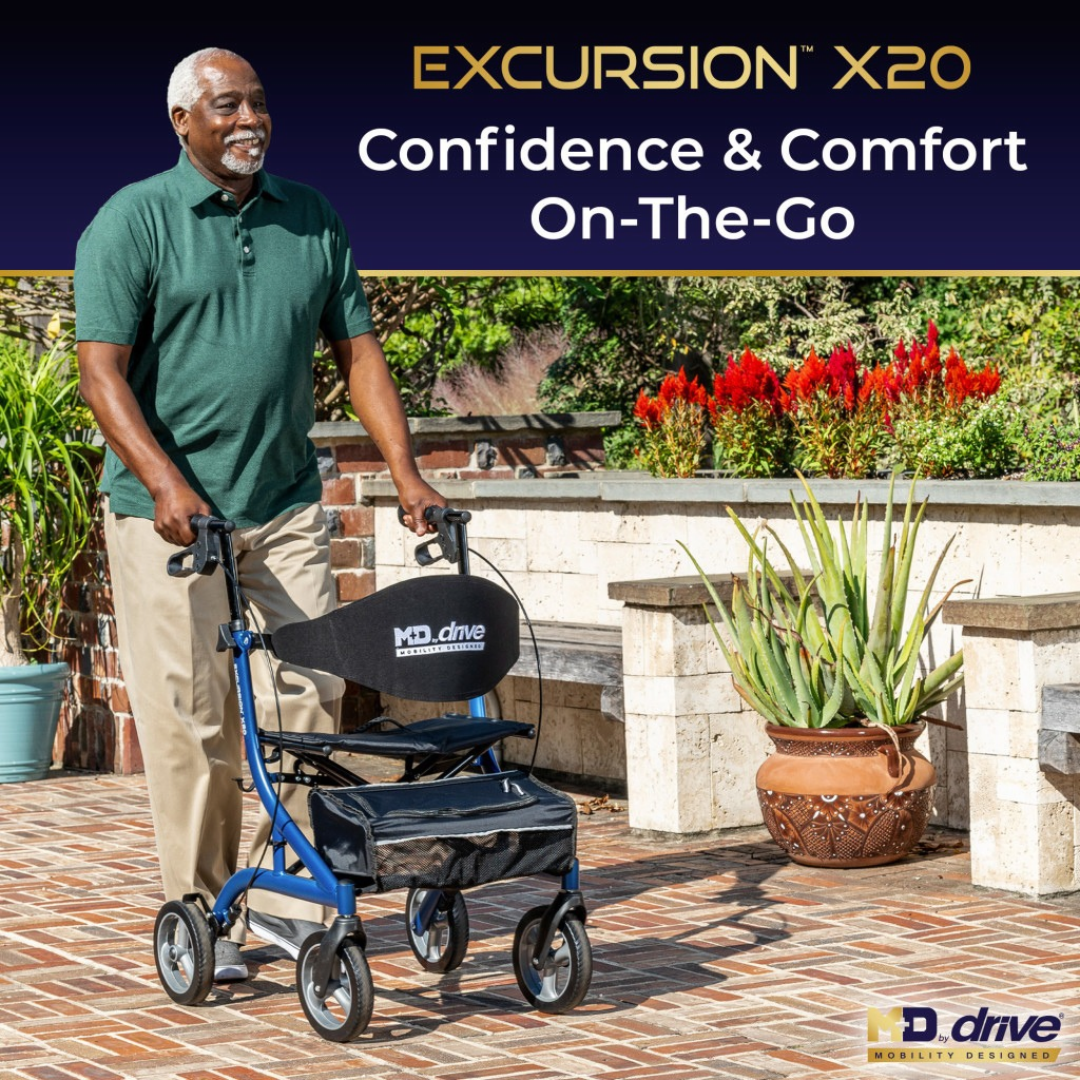 An older man smiles while walking outside using a blue Drive MD Excursion X20 Portable Rollator with a seat and storage pouch.