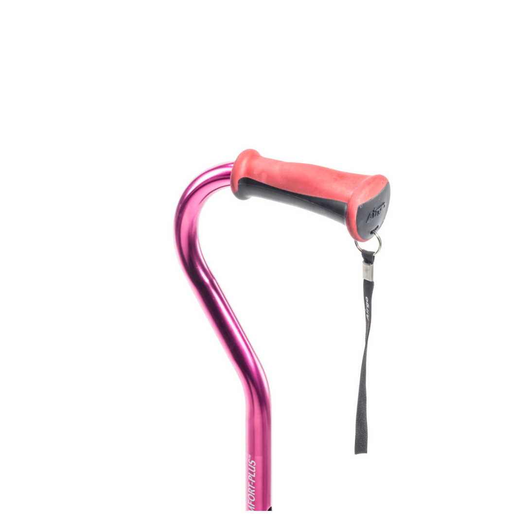 The Drive Airgo Comfort-Plus Aluminum Cane with Offset Handle is shown in metallic pink, featuring a red cushioned comfort-plus handle and a black wrist strap, displayed against a plain white background.