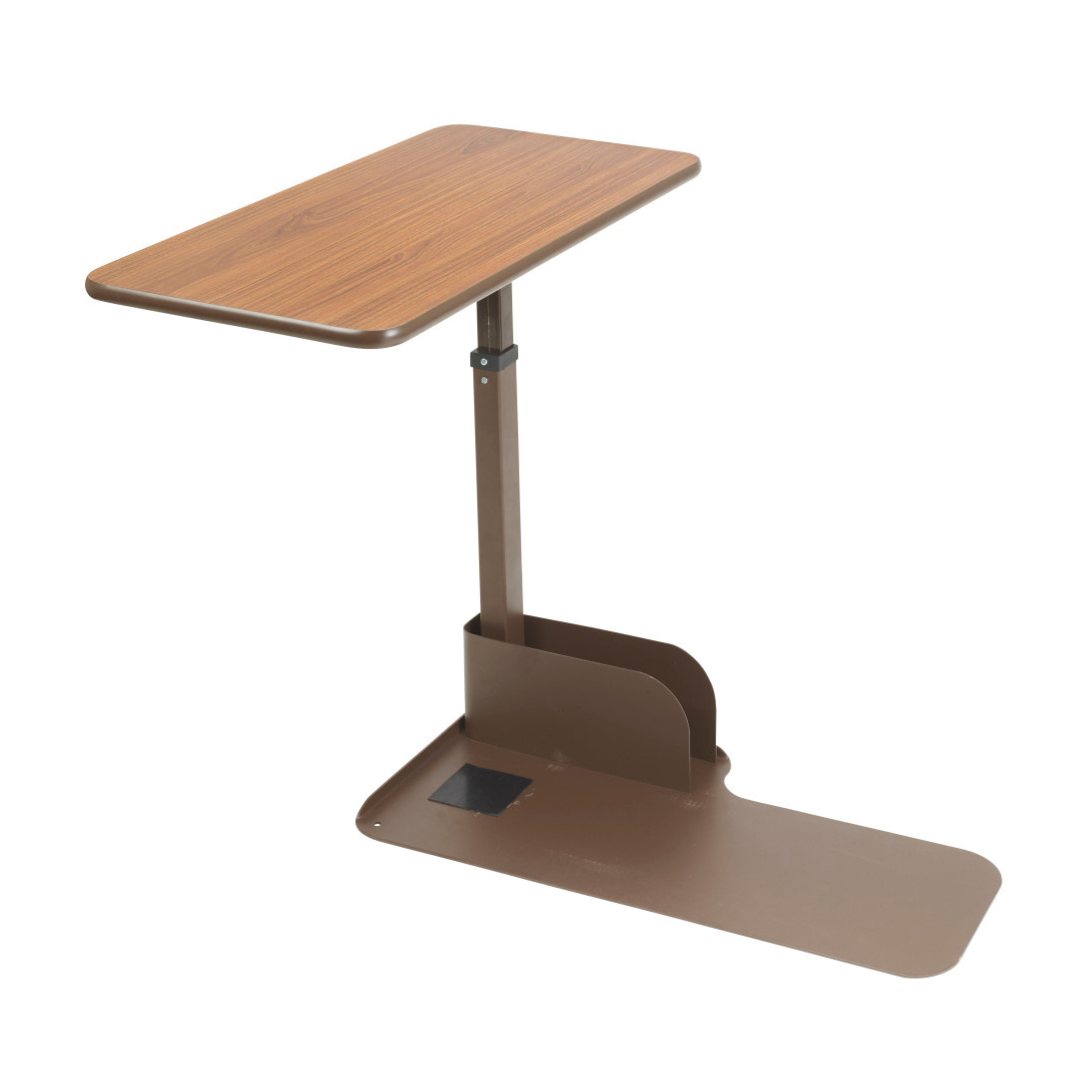 The Drive Couch & Lift Chair Swivel Table features a wood grain rectangular top and brown metal base, slides under beds or chairs for convenience, and offers a pivoting tabletop for added versatility.