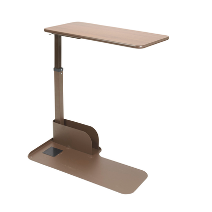 The Drive Couch & Lift Chair Swivel Table is an adjustable, brown table with a flat rectangular, pivoting top and sturdy base—ideal for use beside beds or chairs in homes or hospitals for meals, reading, or other activities.