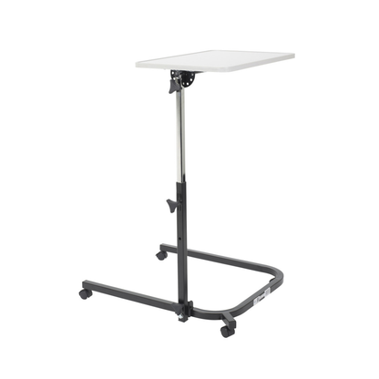 The Drive Pivot & Tilt Overbed Table features a white self-leveling rectangular tabletop, a black metal frame that easily slides under beds or chairs, and four caster wheels for smooth mobility.