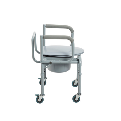 The Drive Steel Drop-Arm Rolling Commode with Padded Armrests is a gray, heavy-duty chair featuring a round seat, drop-arm design, removable bucket, and four caster wheels for mobility, shown against a plain white background.