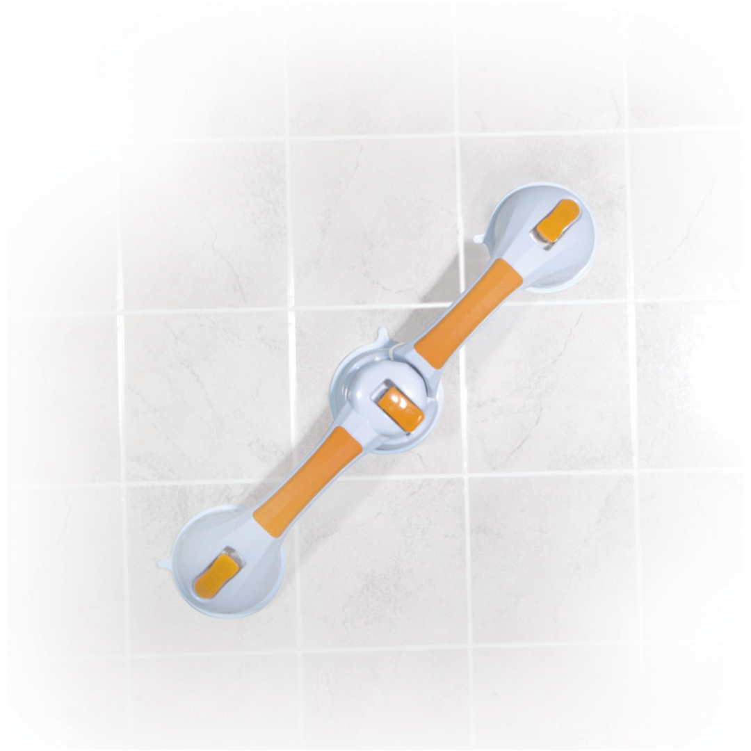 The Drive Shower Rotating Suction-Cup Grab Bar, featuring orange handles and a non-slip grip, is attached diagonally to a tiled wall for added stability and support as a shower or tub grab bar in bathrooms.