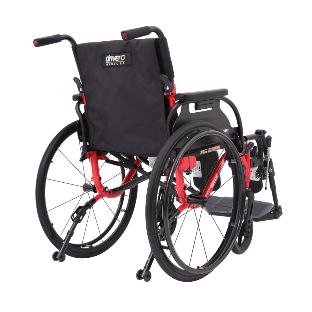 Manual aluminum wheelchair with black seat and red frame, viewed from behind. Large rear wheels, small front wheels, footrests, and push handles highlight this Drive Nitro Cruise Wheelchairs | Ultralight & Portable.