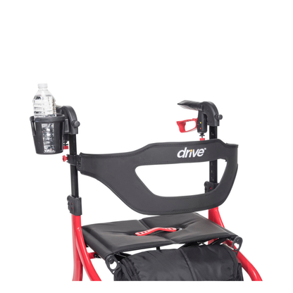 A close-up of a red wheelchair’s backrest with the black Drive logo features the Cup Holder For Drive Nitro Sprint Rollators mounted on the left side, holding a water bottle. Inspired by Nitro Sprint Rollators design.