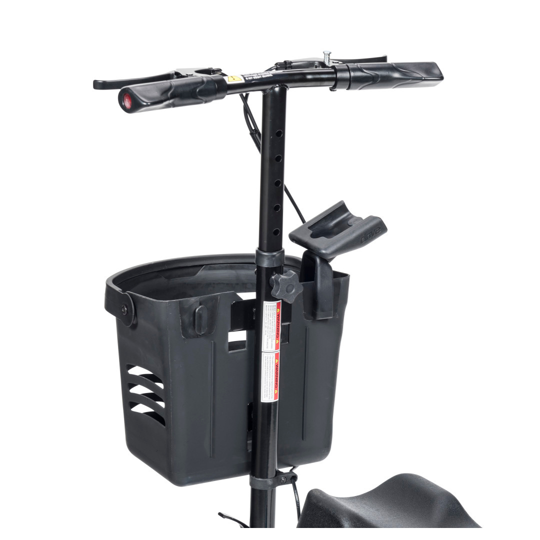 A close-up of a black mobility scooter tiller with handlebars, a front plastic basket, and the Cell Phone Holder For Drive Nitro Sprint and Glide Rollators securely attached to the vertical bar.