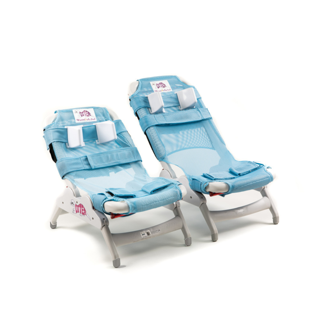 Two blue mesh reclining children's chairs with white frames, adjustable headrests, and safety straps from the Drive Otter Bathing System—waterproof reclining chairs for safe bathing—are shown side by side on a white background.