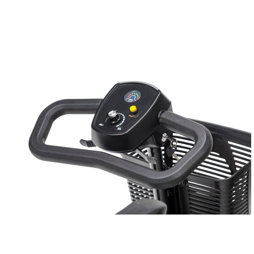 Close-up of a Drive Scout LT 4-Wheel Scooter’s black handlebar with control panel, showing a speed dial, gauges, yellow button, and part of the basket in the background.