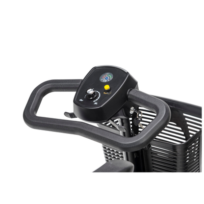 Close-up of a Drive Scout LT 4-Wheel Scooter’s black handlebar with control panel, showing a speed dial, gauges, yellow button, and part of the basket in the background.