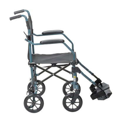 The Drive Travelite Transport Chair is an ultra-compact, foldable travel wheelchair with four large wheels, footrests, armrests, and push handles. Shown from the side against a white background, it includes a rolling travel bag.