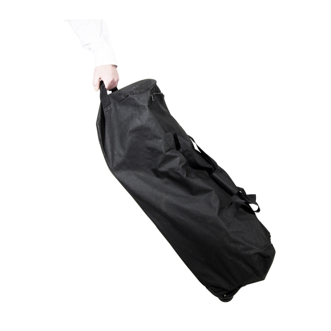 A person holds the ultra compact black rolling travel bag for the Drive Travelite Transport Chair by its handle, set against a white background—perfect for easy transport of your chair.