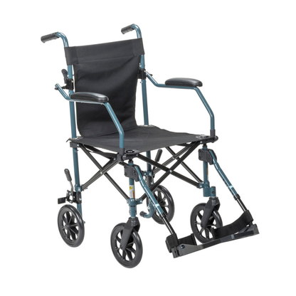 The Drive Travelite Transport Chair is an ultra-compact, lightweight folding wheelchair with a blue frame, black fabric seat and backrest, four small wheels, footrests, armrests, handles, and a rolling travel bag for easy transport.