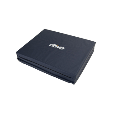 A dark blue, rectangular Drive Tri-Fold Bedside Fall Mat with "drive" in white text on top, made of high-density foam for fall injury prevention and support.