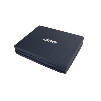 A dark blue, rectangular Drive Tri-Fold Bedside Fall Mat with "drive" in white text on top, made of high-density foam for fall injury prevention and support.