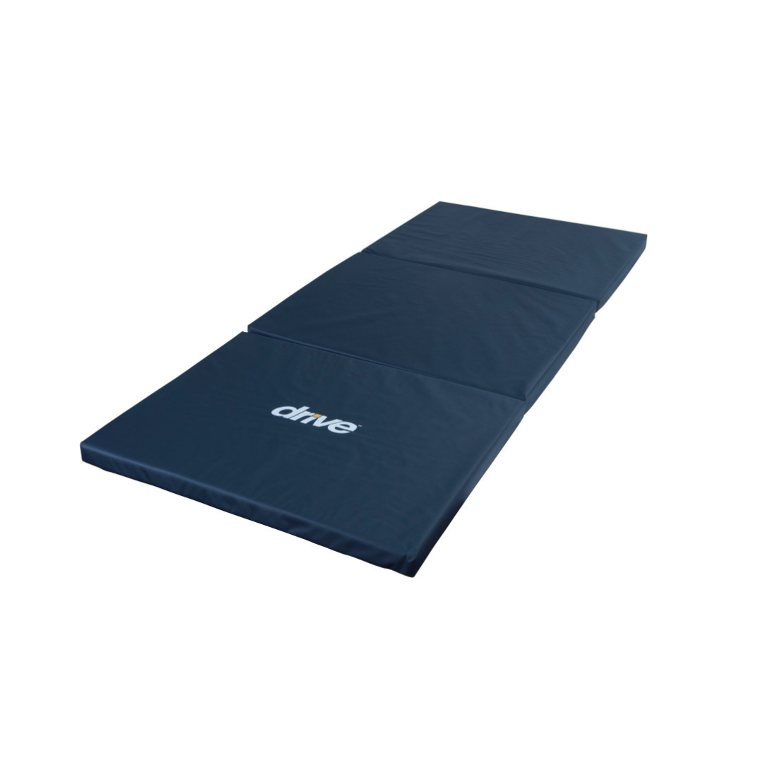 The Drive Tri-Fold Bedside Fall Mat is a dark blue high-density foam safety mat with "drive" printed in white, designed to prevent fall injuries and shown fully extended on a white background.