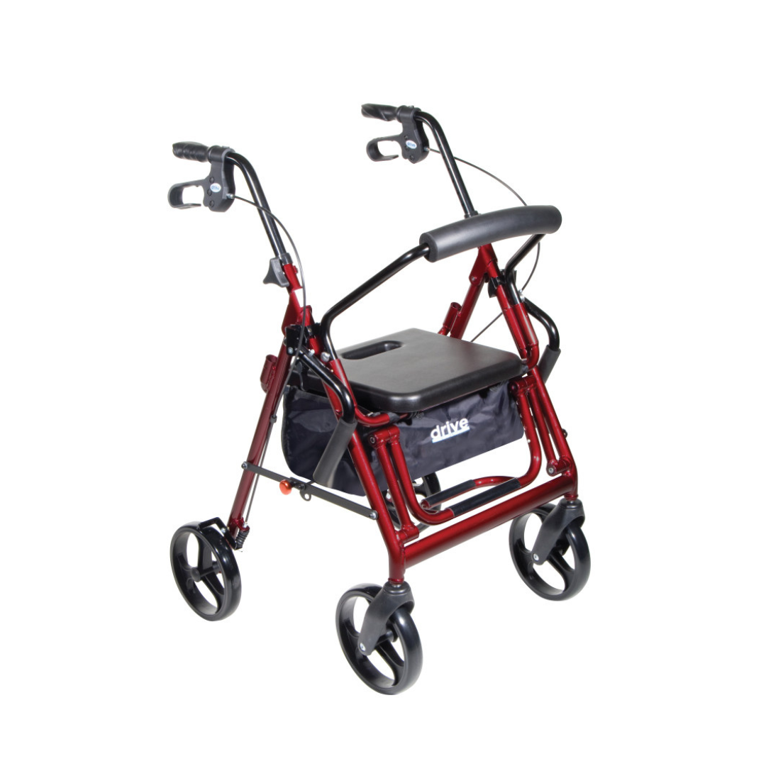 The Drive Hybrid Duet Rollator/Transport Chair in red features a black padded seat, hand brakes on the handlebars, and a storage pouch beneath, shown against a white background.