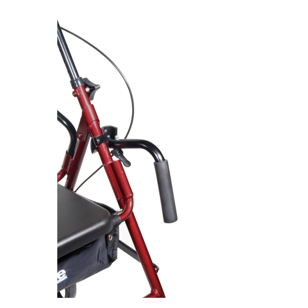 Close-up of the Drive Hybrid Duet Rollator/Transport Chair in red, featuring a black padded seat, handlebar, and attached cables against a white background. Only part of this versatile mobility aid is visible.