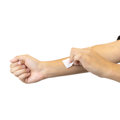 A person cleans their forearm with a Dynarex Alcohol Prep Pad - Sterile, prepping skin for injection against a white background—perfect for showcasing product specs or details.
