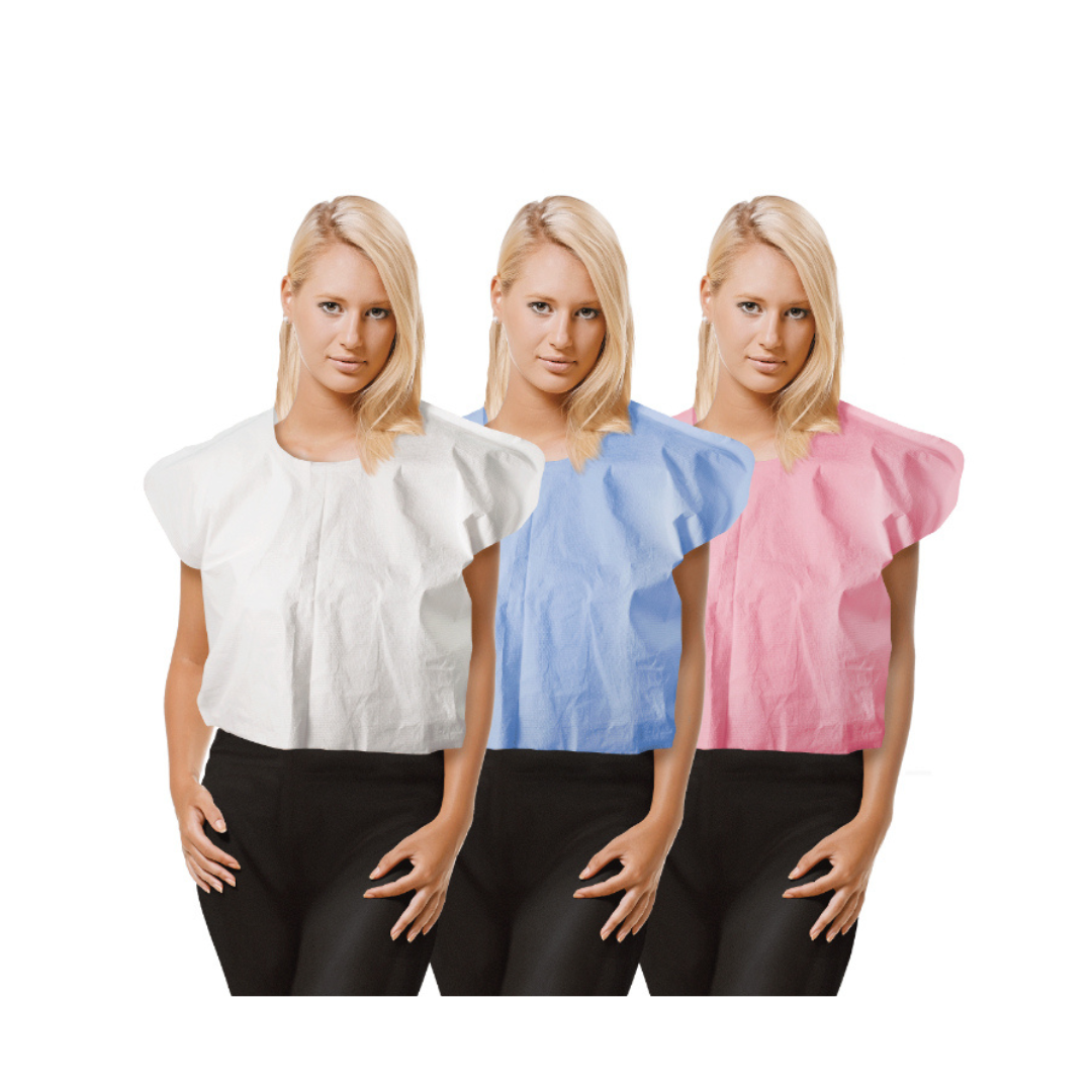 Three women with blonde hair wear Dynarex Exam Capes in white, blue, and pink with black pants, standing side by side against a white background.