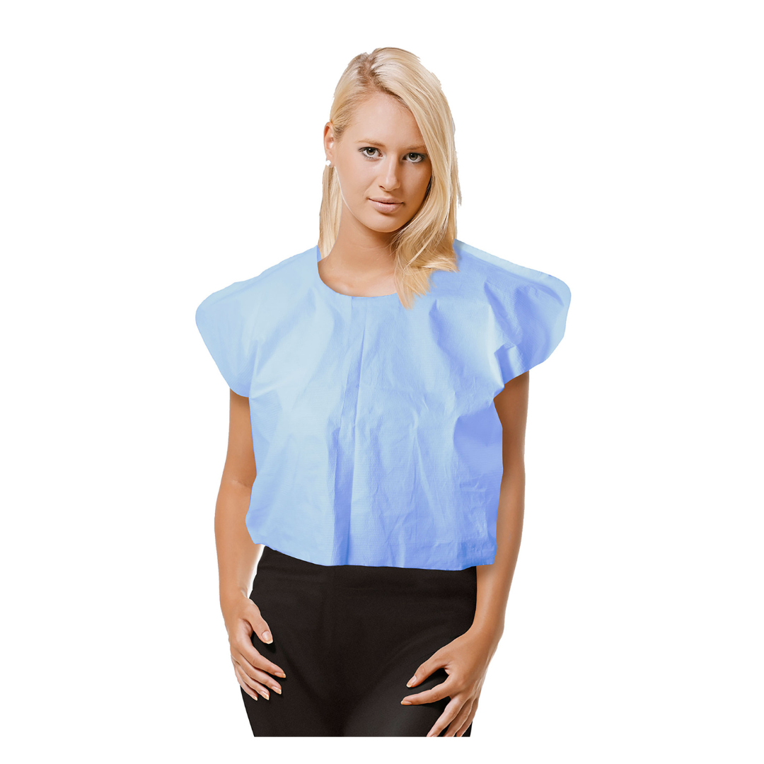 A woman with blonde hair stands against a white background wearing Dynarex Exam Capes in light blue over a black outfit.