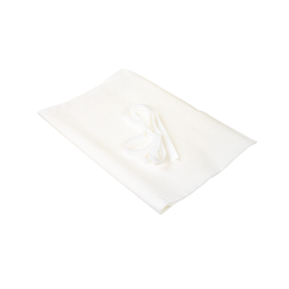 A folded Dynarex Exam Gown—disposable patient gown in white—with a matching fabric belt or tie placed on top, isolated on a white background.