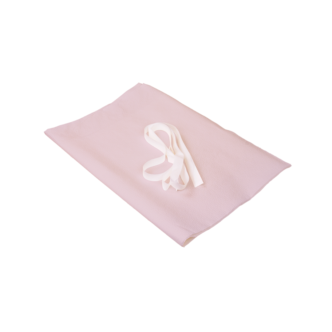 A folded light pink Dynarex Exam Gowns - Disposable Patient Gowns with a white ribbon on top, set against a white background.