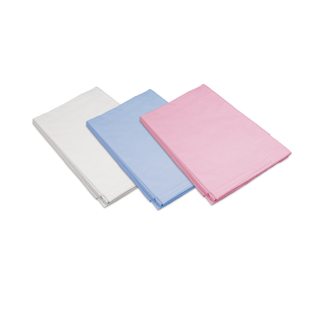 Three folded Dynarex Exam Room Drape Sheets in white, blue, and pink are displayed side by side on a white background.