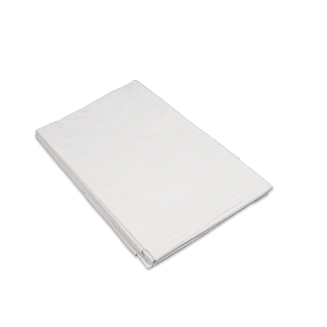 A stack of folded Dynarex Exam Room Drape Sheets is arranged on a white surface and viewed from an angle.