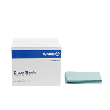 A box labeled Dynarex Exam Room Drape Sheets, Tissue 2-ply, Blue, 100 sheets, 40 x 48, is placed next to a tidy stack of light blue medical drape sheets.