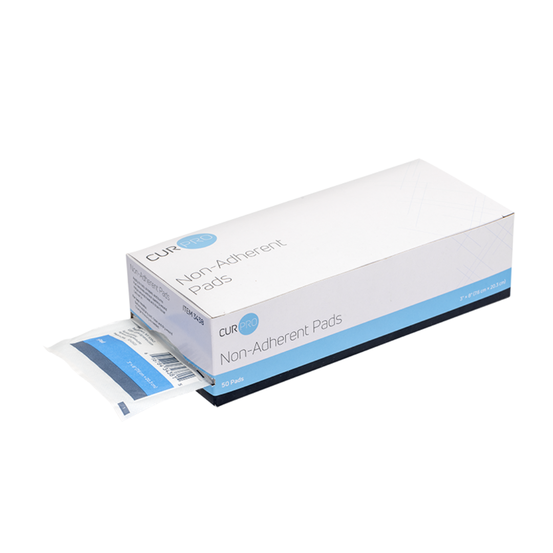 A white and blue box labeled Dynarex Non-Adherent Dressing Pads - Sterile, with one individually wrapped pad partially pulled out from the side. The box contains 50 sterile pads for wound care.