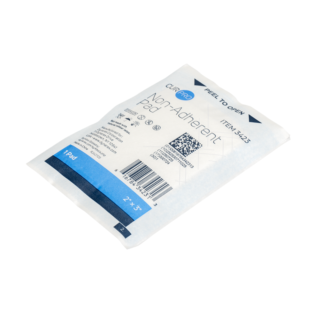 A sealed, rectangular Dynarex Non-Adherent Dressing Pad – Sterile for wound protection in white and blue packaging, labeled 2 x 3 in, with barcode, product details, and Peel to Open instructions—comparable to Curad Pro.