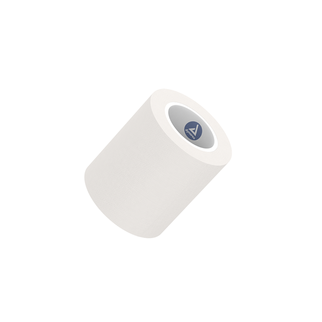 A single roll of Dynarex Paper Surgical Tape is displayed at an angle on a plain white background, with a small blue circular label inside the core, emphasizing its clean, sterile appearance.