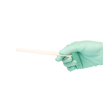 A hand in a light green medical glove holds a Dynarex Wooden Tongue Depressors against a plain white background.