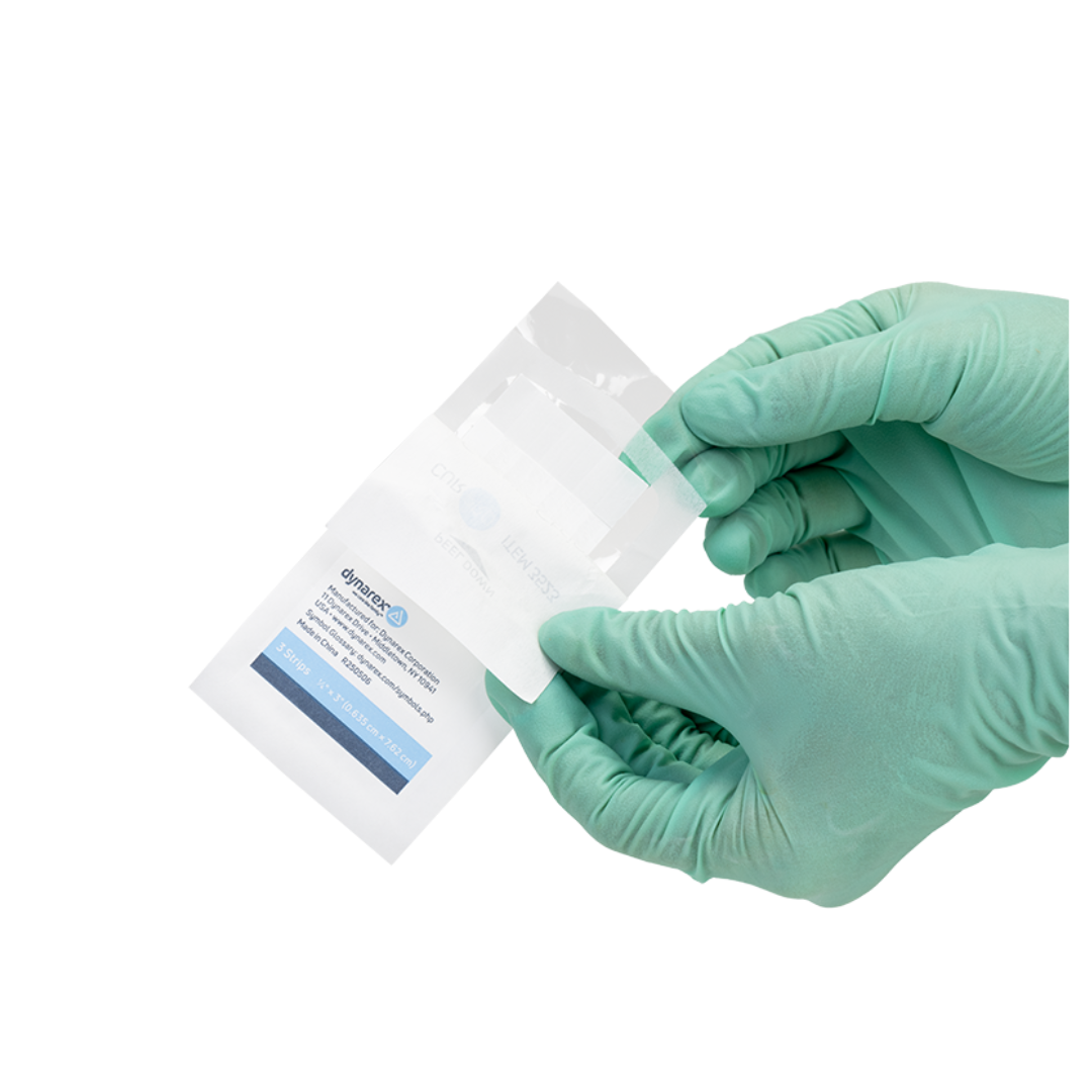 A person wearing light green medical gloves opens a white sterile package containing Dynarex Wound Closure Strips - Sterile against a plain white background.