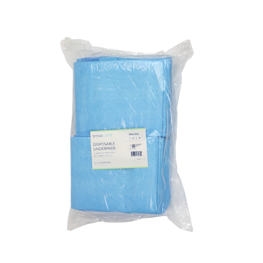 A clear plastic package contains folded blue premium-quality underpads with a white and green label that reads Dynarex Disposable Underpads.