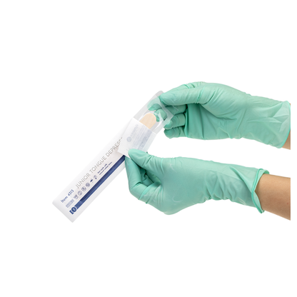 A person in green medical gloves opens a sterile package of Dynarex Wooden Tongue Depressors against a white background.
