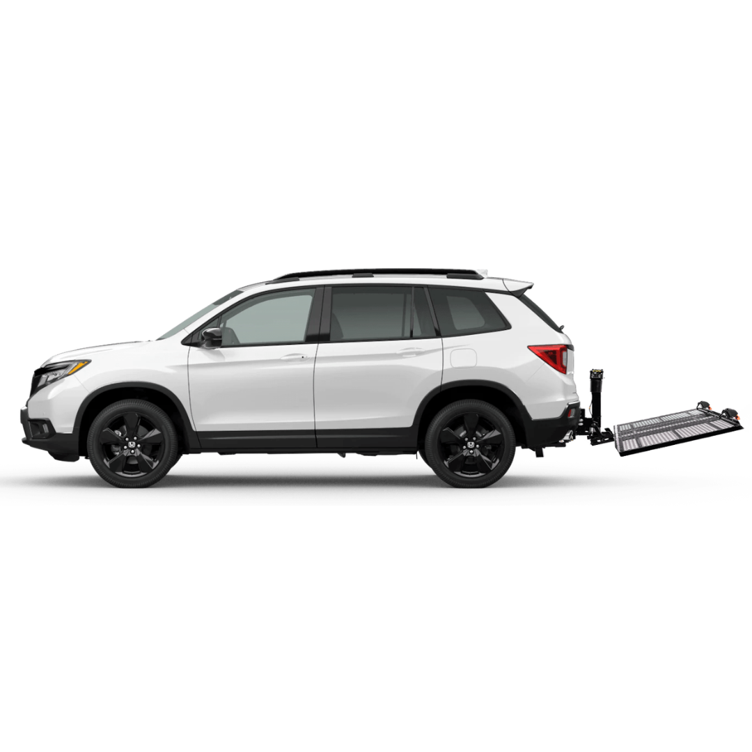 A white SUV seen from the side with an EZ-Carrier Electric Lift – Manual Fold Up (Semi-Auto) hitch-mounted cargo carrier attached to the rear, extending out and empty against a plain white background. See specs or watch videos for details.