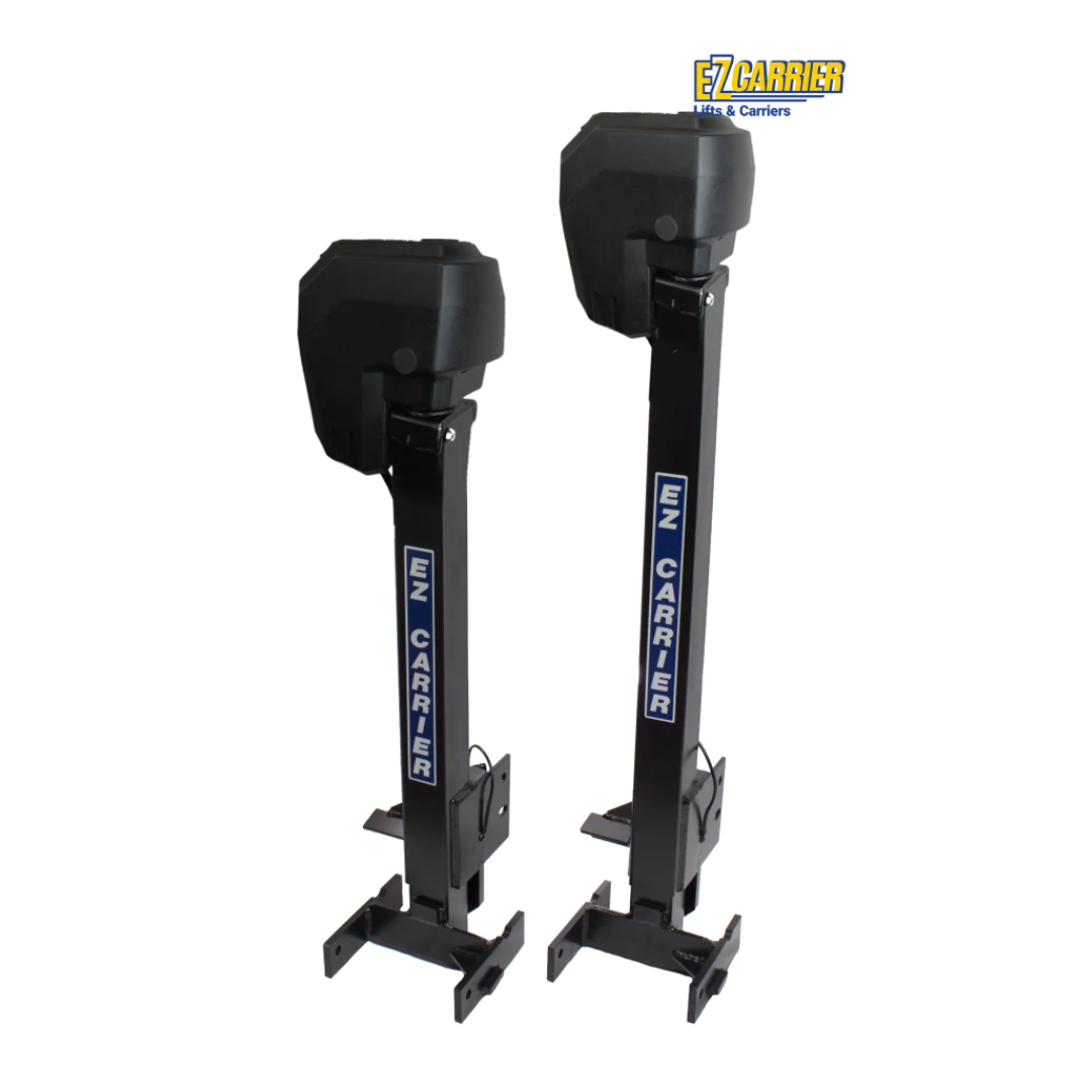 Two black, vertical EZ-Carrier Electric Lift – Manual Fold Up (Semi-Auto) units with rectangular bases and protective covers stand parallel on a white background. The EZ Carrier logo appears on each lift and in the top right corner. Specs and downloads available.