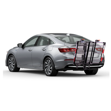 A silver sedan with an EZ-Carrier Electric Lift – Manual Fold Up (Semi-Auto) attached to the rear, featuring a metal cargo carrier, foldable ramp, and red safety reflectors. Check specs or watch videos for more details.